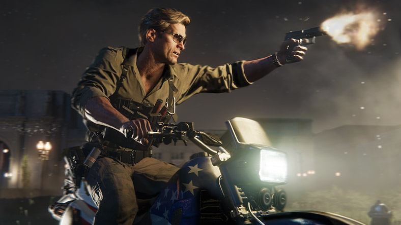 An operative with sunglasses fires their pistol while riding a motorcycle.